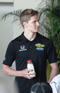 Rookie Josef Newgarden hold his bottle of milk as they prepare to toast this year's rookies.