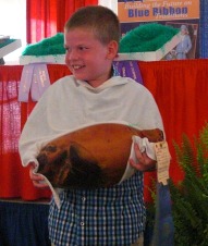 Blue Ribbon winner displaying ham at Governor's Ham Breakfast Auction