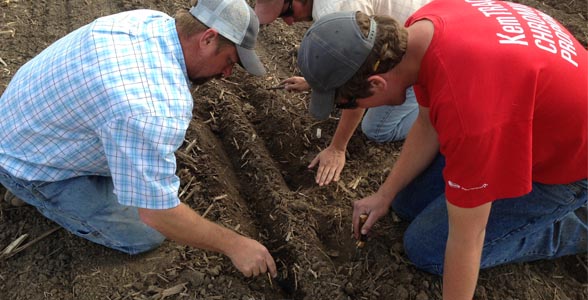 Jason Webster of Beck's Hybrids and his two interns check seed placement on the Variable Hybrid Planter.