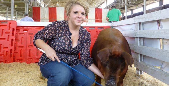 Savanna Williams, Nocona, Tx., with her pig Sugar, prepare to enter the ring for showmanship competition at World Pork Expo, Des Moines, June 6, 2013.