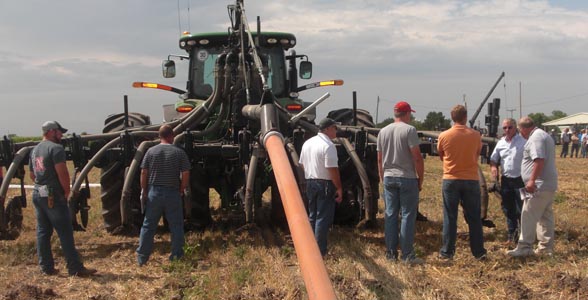 Farmers inspect a continuous flow drag line system during Nebraska Manure Demonstration Day in Lexington.